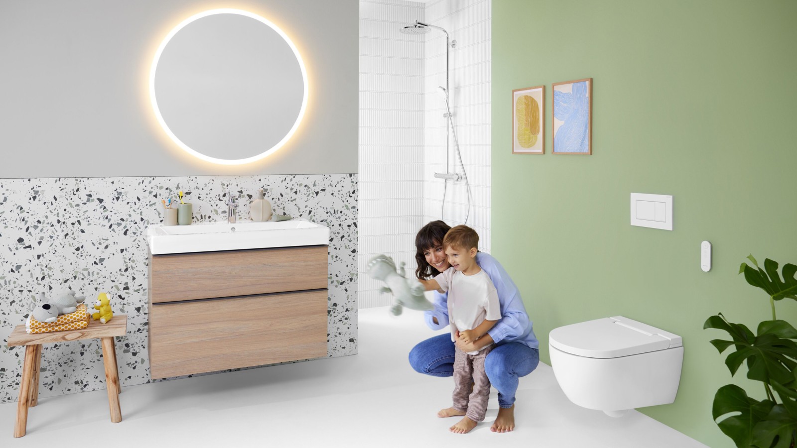 Geberit AquaClean Alba sekä nainen ja lapsi kylpyhuoneessa Geberit AquaClean Alba sekä nainen ja lapsi kylpyhuoneessa